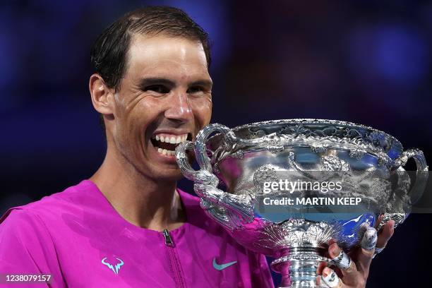 Spain's Rafael Nadal smile as he holds the Norman Brookes Challenge Cup trophy following his victory against Russia's Daniil Medvedev in their men's...