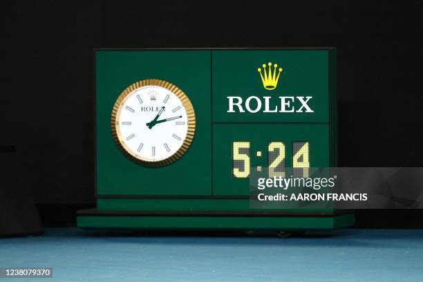 The courtside clock shows the time and the match length after Spain's Rafael Nadal beat Russia's Daniil Medvedev in five sets to win their men's...