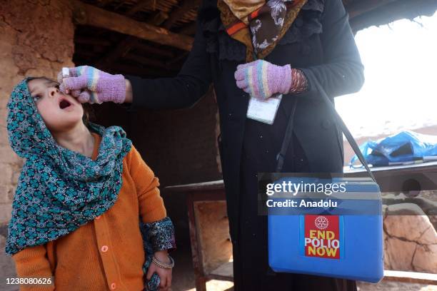 Pakistani health worker administers polio drops to Afghan child during an anti-polio campaign at Afghan refugees settlement in the outskirts of...