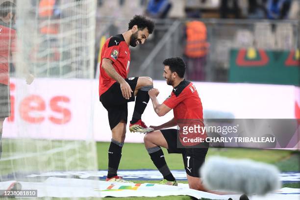 Egypt's midfielder Mahmoud 'Trezeguet' Hassan celebrates with Egypt's forward Mohamed Salah after scoring his team's second goal during the Africa...