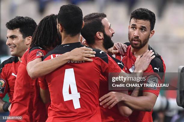 Egypt's midfielder Mahmoud 'Trezeguet' Hassan celebrates with teammates after scoring his team's second goal during the Africa Cup of Nations 2021...