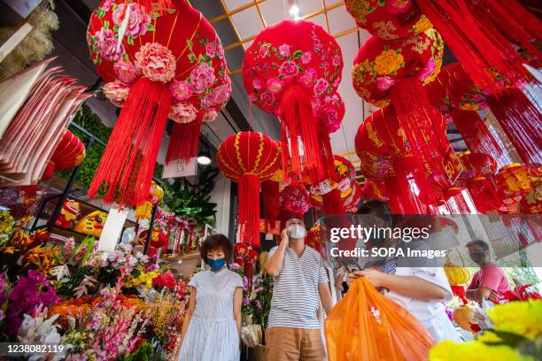 People shop for Lunar New Year decorations at a shop in the Chinatown district ahead of the Lunar New Year celebrations. Lunar New Year falls on...