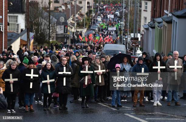 Families of the victims and supporters hold crosses as they take part in Bloody Sunday March to Free Derry Corner, as they mark the 50th Anniversary...
