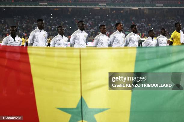 Senegal's players line up behind their national flag prior to the Africa Cup of Nations 2021 quarter-final football match between Senegal and...