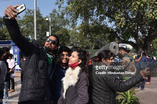 People click selfie after a cannon being fired at Connaught Place as a mark of respect to Father of Nation Mahatma Gandhi on his 74th Death...