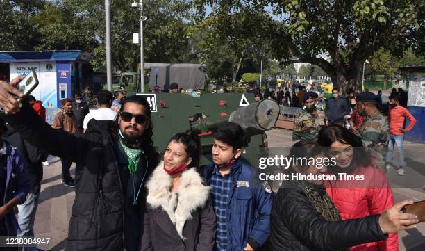 People click selfie after a cannon being fired at Connaught Place as a mark of respect to Father of Nation Mahatma Gandhi on his 74th Death...