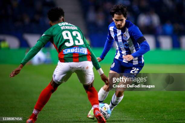 Vitinha of FC Porto and Henrique Rafael of CS Maritimo battle for the ball during the Liga Portugal Bwin match between FC Porto and CS Maritimo at...
