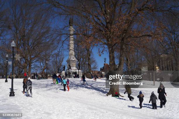 Residents play in the snow at Boston Common park after a blizzard in Boston, Massachusetts, U.S., on Sunday, Jan. 30, 2022. Boston tied a daily snow...