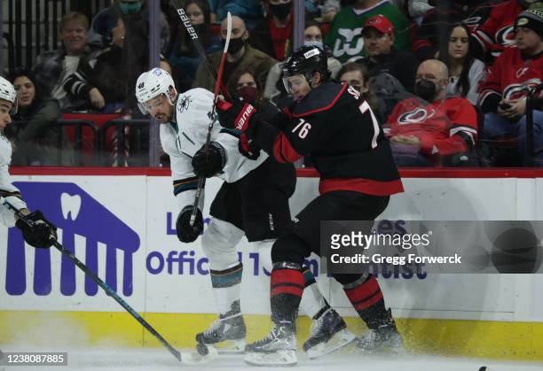 Tomas Hertl of the San Jose Sharks and Brady Skjei battle along the boards for possession of the puck during an NHL game on January 30, 2022 at PNC...