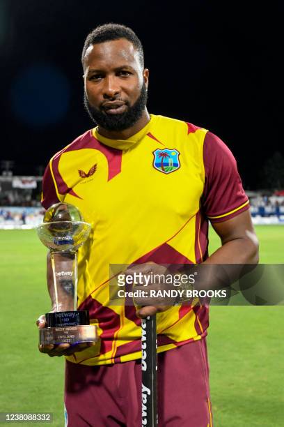 Kieron Pollard of West Indies poses with the winning trophy at the end of the 5th and final T20I between West Indies and England at Kensington Oval,...