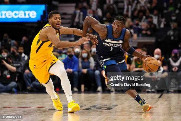 Anthony Edwards of the Minnesota Timberwolves dribbles the ball while Jared Butler of the Utah Jazz defends in the first quarter of the game at...