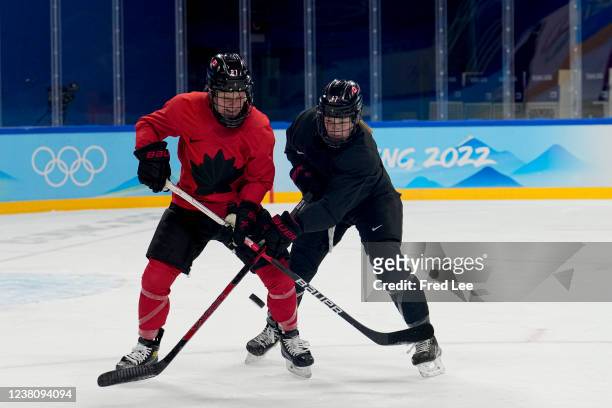 Emma Maltais and Ella Shelton of Team Canada train during a practice session ahead of the Beijing 2022 Winter Olympics at the Wukesong Practice...