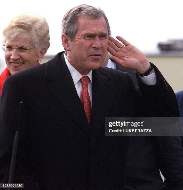 President George W. Bush listens to a reporter's question upon his arrival at Billings Logan International Airport in Billings, Montana, 26 March as...