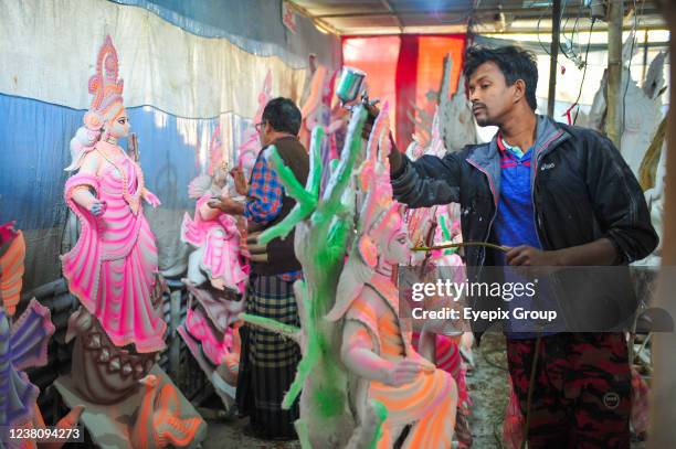 An artist paints a sculpture of the goddess Saraswati in his workshop during the Vasant Panchami, also called Saraswati Puja. It is a religious...