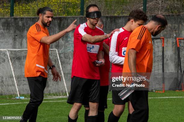 Coach of the Portugal national football team for the blind gives instructions to the players during training at the Porto Pinheiro sports complex,...