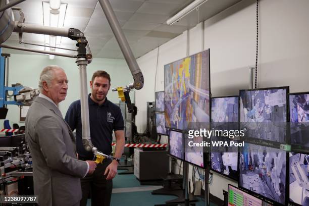 Prince Charles, Prince of Wales operates equipment in the remote handling control room at the UK Atomic Energy Authority in Culham on January 31,...