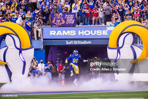 Los Angeles, CA Rams fans cheer as Rams defensive lineman Aaron Donald leaps in the air while taking the field at the start of the NFC Championships...
