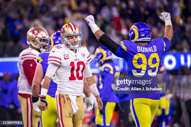 Los Angeles, CA Rams defensive lineman Aaron Donald, right, celebrates as 49ers quarterback Jimmy Garappolo, left, walks away dejected after he...