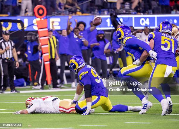 Los Angeles, CA Rams defensive lineman Aaron Donald sacks 49ers quarterback Jimmy Garappolo, left, as he fumbs the ball in the final minutes of the...