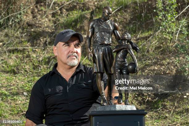 Sculptor Dan Medina of West Hills is photographed next to his bronze statue of Los Angeles Lakers legend Kobe Bryant and his daughter Gianna that he...