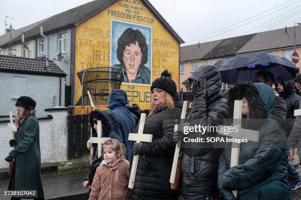 Relatives and family members of the victims of the 1972 Blood Sunday massacre hold crosses and march through the Catholic Nationalist Creggan estate....
