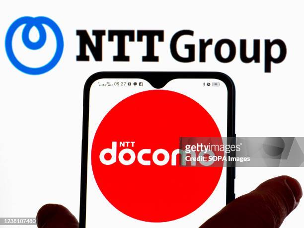 In this photo illustration, the NTT Docomo logo is displayed on a smartphone screen with the Nippon Telegraph and Telephone Corporation logo in the...