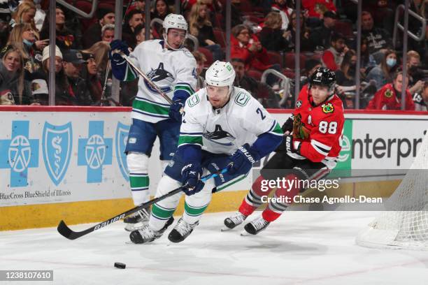 Luke Schenn of the Vancouver Canucks approaches the puck ahead of Patrick Kane of the Chicago Blackhawksin the second period at United Center on...