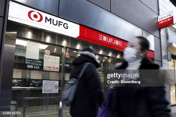 Pedestrians in front of a branch of MUFG Bank Ltd., a unit of Mitsubishi UFJ Financial Group Inc. , in Tokyo, Japan, on Monday, Jan. 31, 2022....