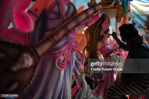 An artist paints a sculpture of the goddess Saraswati during the preparations for the Vasant Panchami Festival, also called Saraswati Puja, in honor...