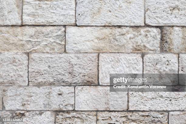 sandstone white blocks wall texture - beige brick stock pictures, royalty-free photos & images