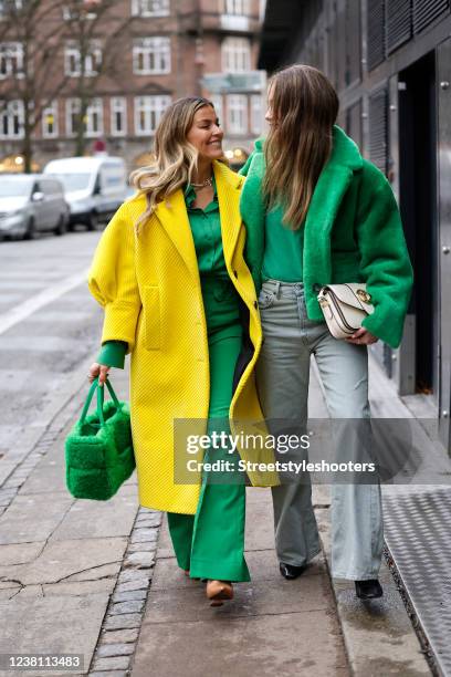 Influencer Janka Polliani wearing a yellow coat by Prada, a green blouse by Gucci, matching green wide leg pants by Gucci, a green fuzzy bag by...