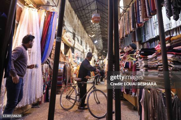 Syrians are pictured in the covered Hamidiyah bazaar in the old city of Syria's capital Damascus on February 1, 2022.