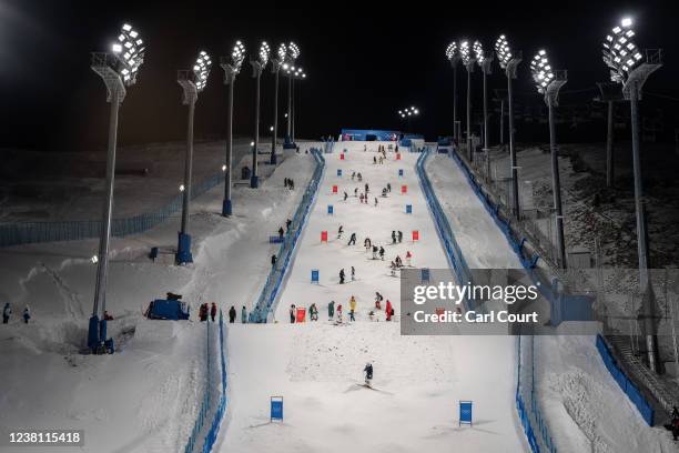 Team members check the course before a freestyle skiing moguls practice session at Genting Snow Park on February 1, 2022 in Zhangjiakou, China. With...