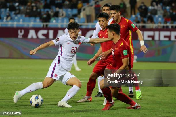 Vietnams Bui Hoang Viet Anh fights for the ball with Chinas Zhu Chenjie during the FIFA World Cup Asian Qualifier final round Group B match between...