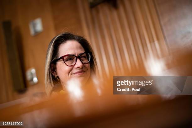 Senator Kyrsten Sinema , listens during a Senate Homeland Security and Governmental Affairs Committee confirmation hearing for Shalanda Young,...