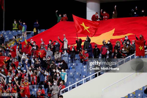 Vietnamese soccer fans cheer during the FIFA World Cup Asian Qualifier final round Group B match between Vietnam and China at My Dinh National...