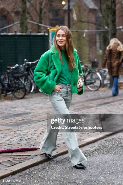 Influencer Annabel Rosendahl wearing a green faux fur teddy jacket by Onar, a green sweater by Loulou Studios, grey flared denim jeans pants by Acne...