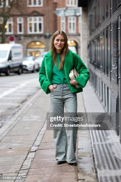 Influencer Annabel Rosendahl wearing a green faux fur teddy jacket by Onar, a green sweater by Loulou Studios, grey flared denim jeans pants by Acne...