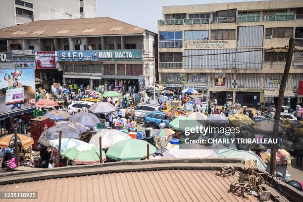 This picture taken on January 31, 2022 in Yaounde shows people walking in the central market of the cameroonian capital city.