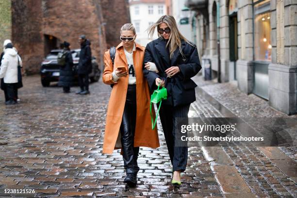 Influencer Caroline Ebo wearing an orange coat by REMAIN Birger Christensen, a white jumper by ROTATE Birger Christensen, black sneaker by...