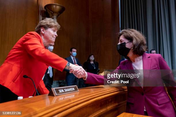 Chair Sen. Jeanne Shaheen, D-N.H., left, speaks with Commerce Secretary Gina Raimondo, right, following her testimony before a Senate Appropriations...