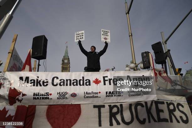 Protesters waiving signs in front of the Parliament building during the 4th Day of Trucker's protest against the mandatory vaccine policy imposed on...
