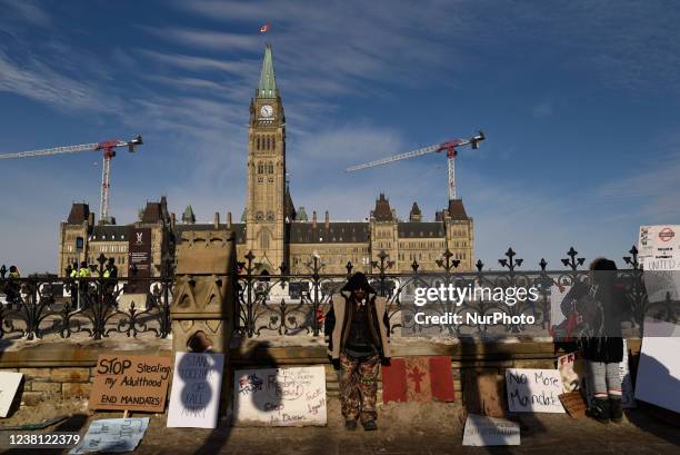 Signs and banners on the Parliament building fence during the 4th Day of Trucker's protest against the mandatory vaccine policy imposed on the...