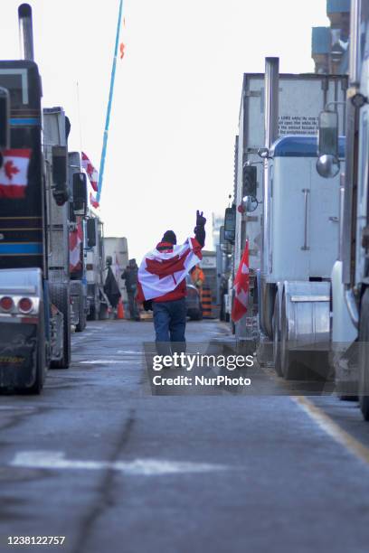 Supporter showing victory sign during the 4th Day of Trucker's protest against the mandatory vaccine policy imposed on the Canadian truckers...