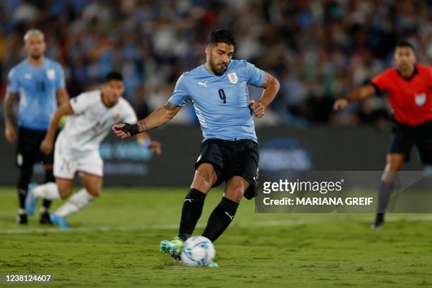 Uruguay's Luis Suarez shoots a penalty kick to score a goal against Venezuela during the South American qualification football match for the FIFA...