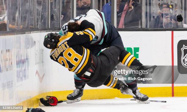 Derek Forbort of the Boston Bruins fights Jeremy Lauzon of the Seattle Kraken during the second period at the TD Garden on February 1, 2022 in...