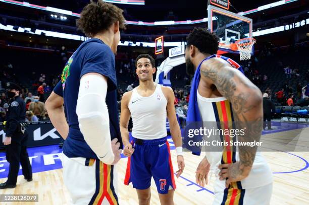 Frank Jackson of the Detroit Pistons talks with Jaxson Hayes of the New Orleans Pelicans and Nickeil Alexander-Walker of the New Orleans Pelicans...