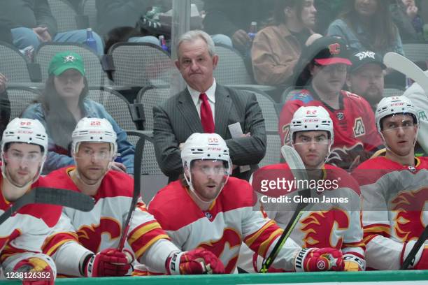 Darryl Sutter of the Calgary Flames watches the action from behind the bench against the Dallas Stars at the American Airlines Center on February 1,...