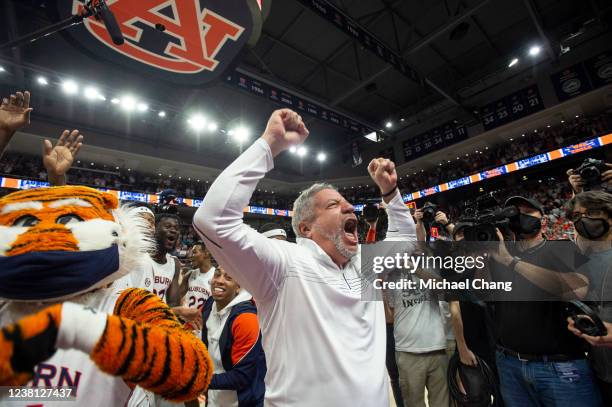 Head coach Bruce Pearl of the Auburn Tigers celebrates with his team after defeating the Alabama Crimson Tide at Auburn Arena on February 01, 2022 in...