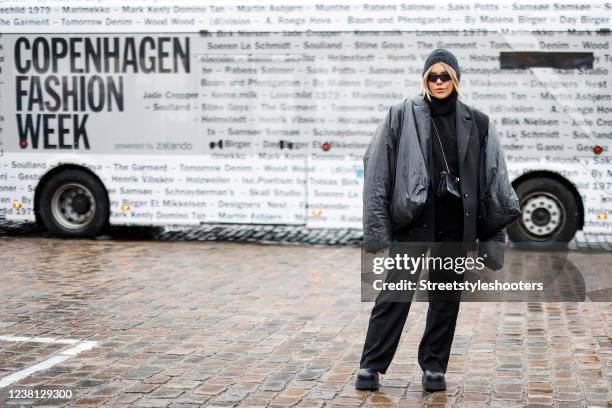 Influencer Gigi Vives wearing a black jacket by Yeezy x Gap, a black blazer by Mango, a black hoodie by Weekday, black pants by na-kd, black boots by...